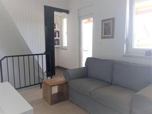 a living room with a couch and a staircase at Lovely flat, city center with free parking in Varaždin