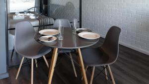 a dining room table with four chairs and a table and a counter at Wex1 Style living in Cape Town