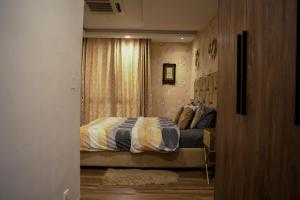 a bedroom with a bed and a window at Luxury 1 Bedroom Apartment Gold Crest Mall And Residency DHA in Lahore