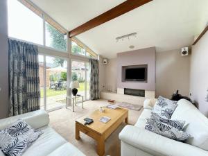 a living room with a white couch and a table at 3 Chatsworth Road, Worsley in Manchester