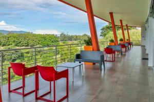 a row of tables and chairs on a balcony at Charming Retreat Heredia: Your Home Away from Home in Heredia