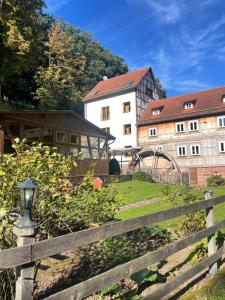 a wooden fence in front of a building at Pension Untere Mühle in Burghaun