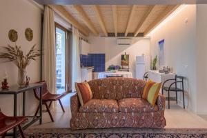 a living room with a couch and a table at In Riva al Lago di Iseo Dependance Piano Terra in Marone