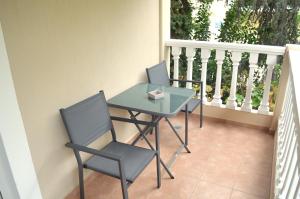 two chairs and a table on a balcony at Μοντέρνο Studio στο Κέντρο της Λάρισας in Larisa