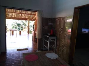 a room with a table and a door to a patio at Vila Linda Flor in São José dos Campos