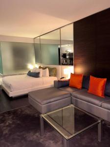 a living room with a couch and a bed at Amazing view 18th floor at Palms place Las Vegas in Las Vegas