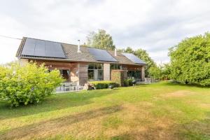 a house with solar panels on the roof at Superbe et chaleureux gîte familial in Beauraing