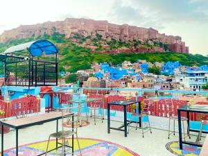a view of a city with colorful tables and chairs at Golden Dreams Guest House in Jodhpur