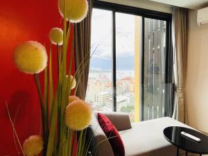 a living room with a couch and a large window at THE EDGE 2025 New in Pattaya Central +110 photos
