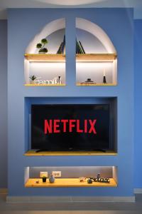 a tv in a wall with a netflix sign on it at Vibrant Apartment in Tirana