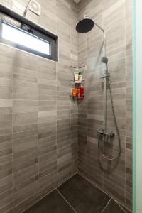 a shower stall with a shower head in a bathroom at Renovated 3-bedroom House in Nature - Iskia Estate in Martvili