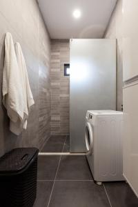 a bathroom with a washer and dryer in it at Renovated 3-bedroom House in Nature - Iskia Estate in Martvili