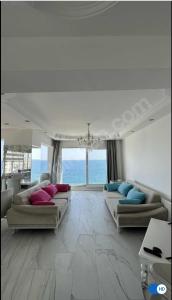 a large living room with two couches and the ocean at Antalya Konyaaltı Plajında dublex GEMİ EV in Antalya