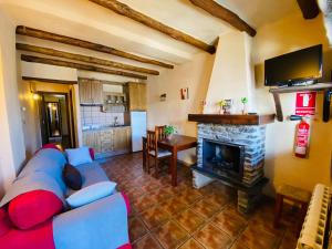 a living room with a blue couch and a fireplace at Muley Hacén in Capileira