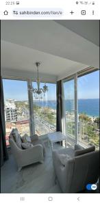 a living room with couches and a view of the ocean at Antalya Konyaaltı Plajında dublex GEMİ EV in Antalya