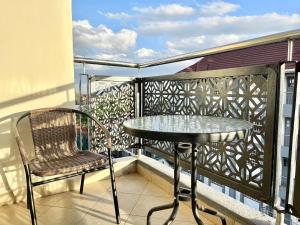 a table and a chair on a balcony at Neema Executive Suites Near Junction Mall With Balcony in Nairobi