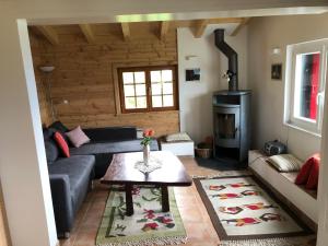 a living room with a couch and a stove at Chalet avec vue imprenable et au calme in Chalais