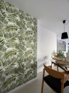 a room with a wall with a leafy wallpaper at Sunny Cozy & Pretty Penthouse in Central SC in Santa Cruz de Tenerife
