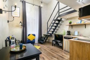 a kitchen and a living room with a spiral staircase at Luxury apartment in the city center with parking in Budapest