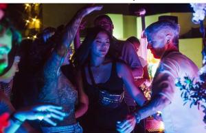 a group of people dancing at a party at Marco Polo Party Hostel in St. Julianʼs