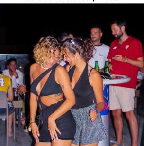 two women standing next to each other at a party at Marco Polo Party Hostel in St. Julianʼs