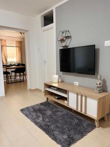 a living room with a flat screen tv on a wall at Apartman Luna *** in Rijeka