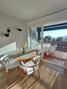 a dining room with a table and chairs and a balcony at La calma de Tossa in Girona