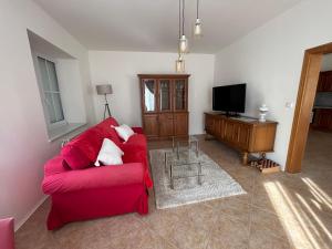 - un salon avec un canapé rouge et une télévision dans l'établissement Apartmán Svítkov 21, à Pardubice