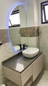 a bathroom with a sink and a mirror at Cómodo apartaestudio in Santa Rosa de Cabal +2 photos