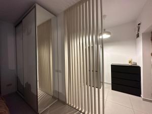 a room with a hallway with a closet and a dresser at Fundeni house 250C in Bucharest