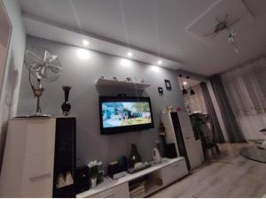 a living room with a flat screen tv on the wall at Czuj się jak u siebie in Zamość