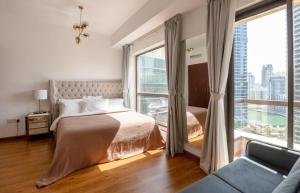 a bedroom with a bed and a large window at Beautiful stylish 1 bedroom by the JBR beach ! in Dubai