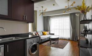 a kitchen and living room with a couch at Beautiful stylish 1 bedroom by the JBR beach ! in Dubai