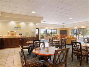 a dining room with tables and chairs in a restaurant at Days Inn by Wyndham Metter in Metter