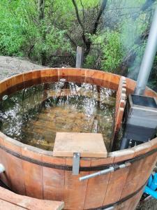 a wooden barrel with a pond of water in it at Casa Cochrane in Cochrane