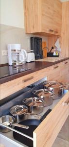 a kitchen with a stove with pots and pans on it at Eibauer Apartments in Sinsheim