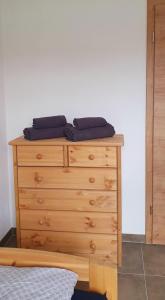 a wooden dresser with two pillows on top of it at Eibauer Apartments in Sinsheim