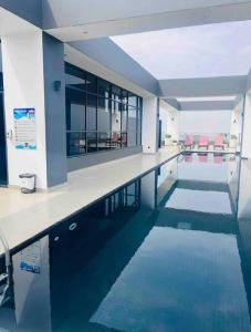 a swimming pool in a building with blue water at Cosy Home in Westlands in Nairobi