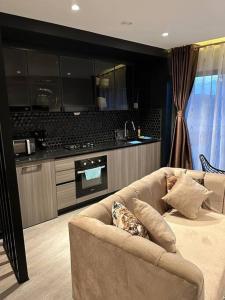 a living room with a couch and a kitchen at Cosy Home in Westlands in Nairobi