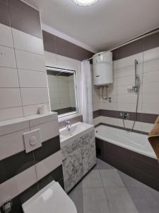 a bathroom with a tub and a toilet and a sink at Hidden Gem in Mostar +30 photos