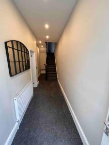a hallway with a stairway leading up to a building at Modern 5 Bedroom Terraced Luxurious House in Colwyn Bay
