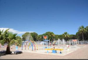 um parque infantil com um parque aquático com um escorrega aquático em Mobilhome 6 personnes Camping Oasis Village 5 étoiles em Puget-sur Argens