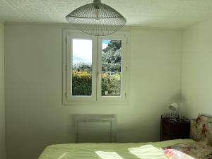 a bedroom with a bed and a window at Villa Bleu soleil in Pornic +4 photos