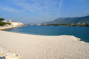 a beach with a large body of water at Apartments for families with children Solin, Split - 21472 in Solin