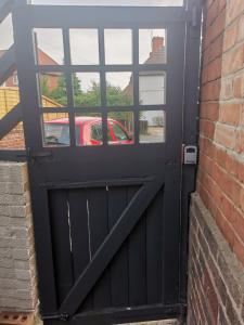 a black garage door with a car in the window at Single room Beeston wollaton park near University in Nottingham