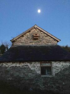 a moon sitting on top of a stone building at KilquiteBarn, Peace and Quiet in Cornwall! in Saltash