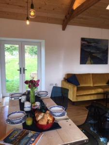 a living room with a table and a couch at KilquiteBarn, Peace and Quiet in Cornwall! in Saltash