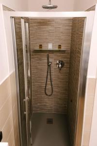 a shower with a hose in a bathroom at B&B Spina Verde in Como