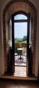 an open door to a balcony with a table at La Casa nel Borgo in San Felice del Benaco