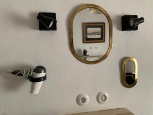 a bathroom with a mirror and a hair dryer at Casa Del Fogón, En La Calle Del Castillo in Vejer de la Frontera